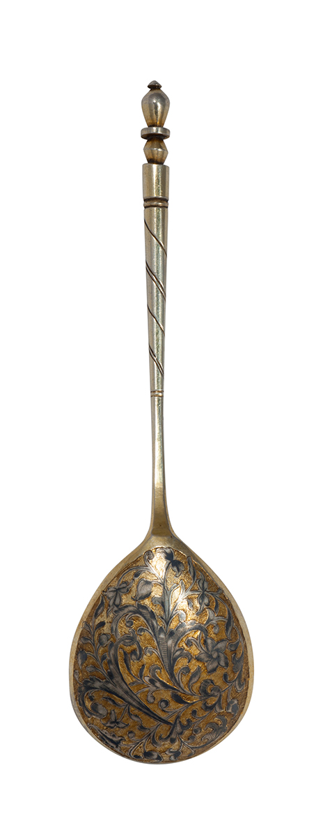 Honey spoon with black floral design.